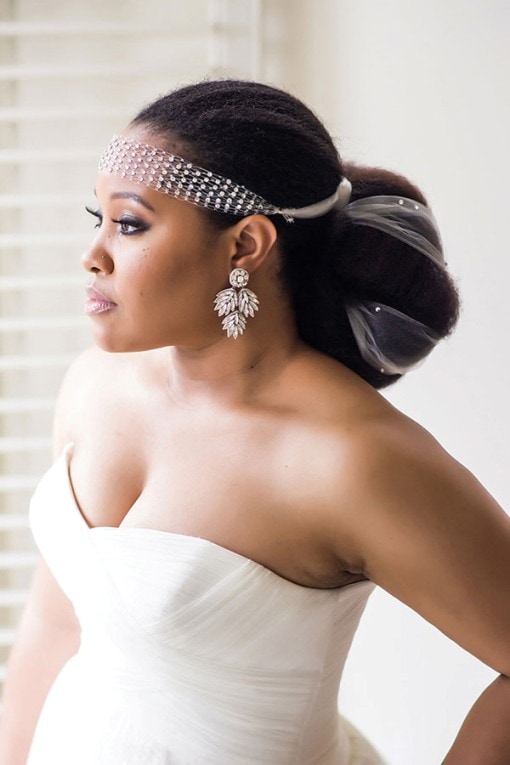 Bride with elegant hairstyle and jeweled headband.