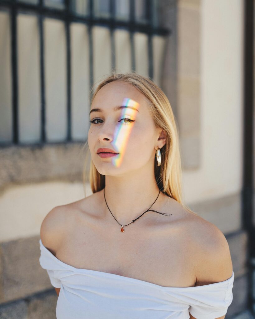 Woman with rainbow light on her face.